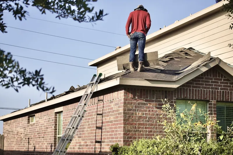 Professional roofer working on a residential roof in Glen Carbon